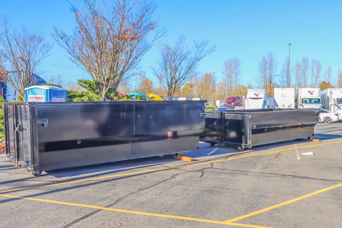 Professional dumpster rental service with roll-off container on residential driveway in Kodiak